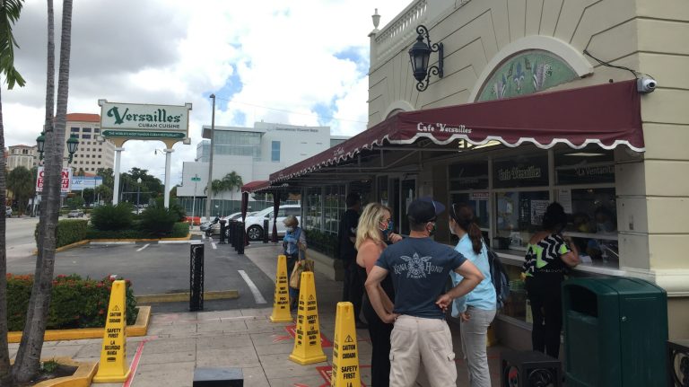 Cafe Versailles in Miami's Little Havana is a gathering place for many Cuban Americans, who sip Cuban espresso and debate politics loudly, even as coronavirus restrictions keep them from gathering at the window.