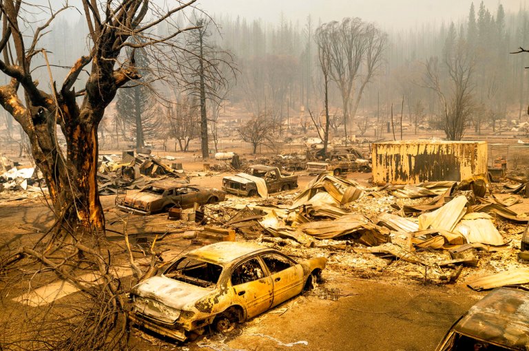 This photo shows cars and homes destroyed by the Dixie Fire line in central Greenville on Thursday, Aug. 5, 2021, in Plumas County, California.