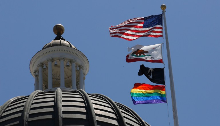 The rainbow Pride flag flutters from the flag pole at the state Capitol in Sacramento, Calif., Monday, June 17, 2019. To honor June as LGBTQ Pride Month, Gov. Gavin Newsom ordered the flag be raised and flown at the Capitol through July 1. While the Capitol has displayed the flag before, the Governor's office says this is the first time it has flown on the main flagpole.