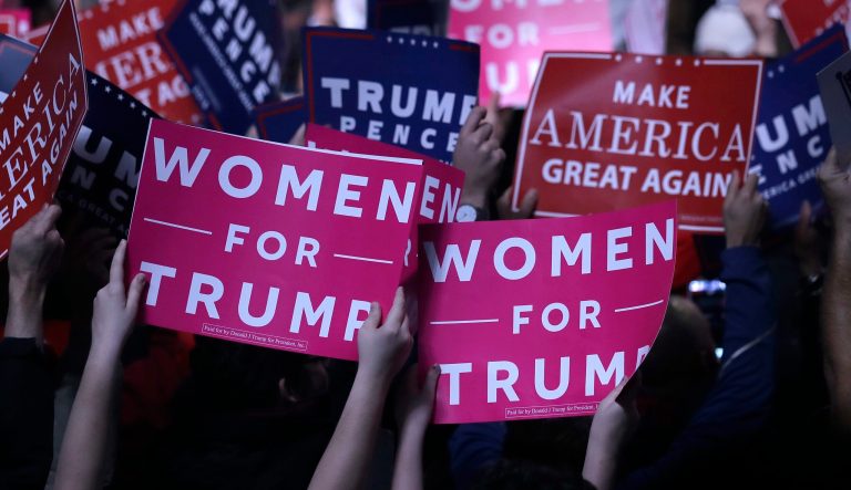 Supporters hold "Women for Trump" signs before a campaign rally for Republican presidential candidate Donald Trump, Monday, Nov. 7, 2016, in Manchester, N.H.
