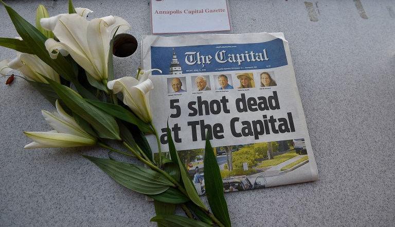 A memorial for Capital Gazette sports writer John McNamara is displayed at a seat in the press box before a baseball game between the Baltimore Orioles and the Los Angeles Angels, Friday, June 29, 2018, in Baltimore. McNamara is one of five victims in a  shooting in the newspaper's newsroom Thursday in Annapolis, Md.