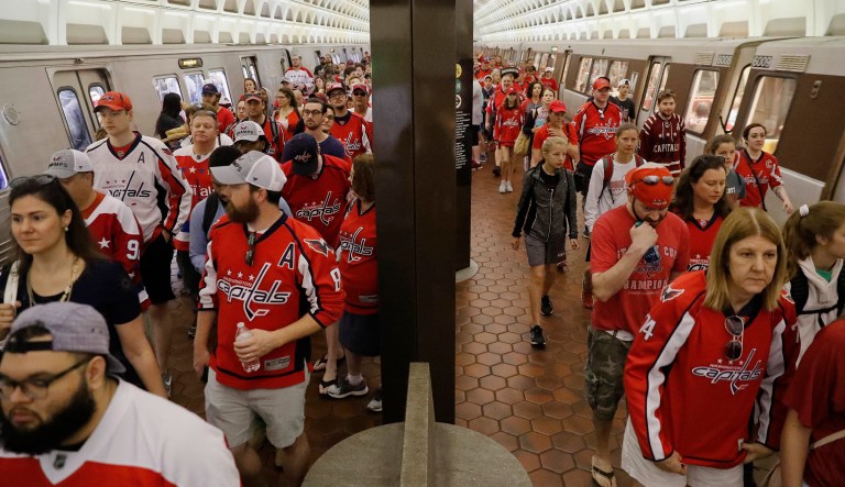 People wait on the platform to use the escalator as they begin to exit the National Archives Metro Subway station and head towards the Washington Capitals Stanley Cup victory parade on the National Mall in Washington, Tuesday, June 12, 2018.