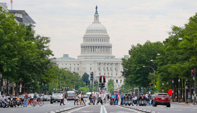 Pedestrians walk across Pennsylvania Avenue in downtown Washington.