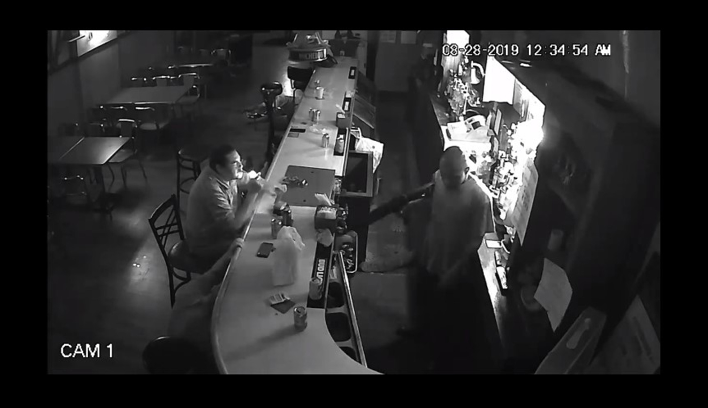 WATCH: Patron nonchalantly lights up cigarette as armed man robs bar