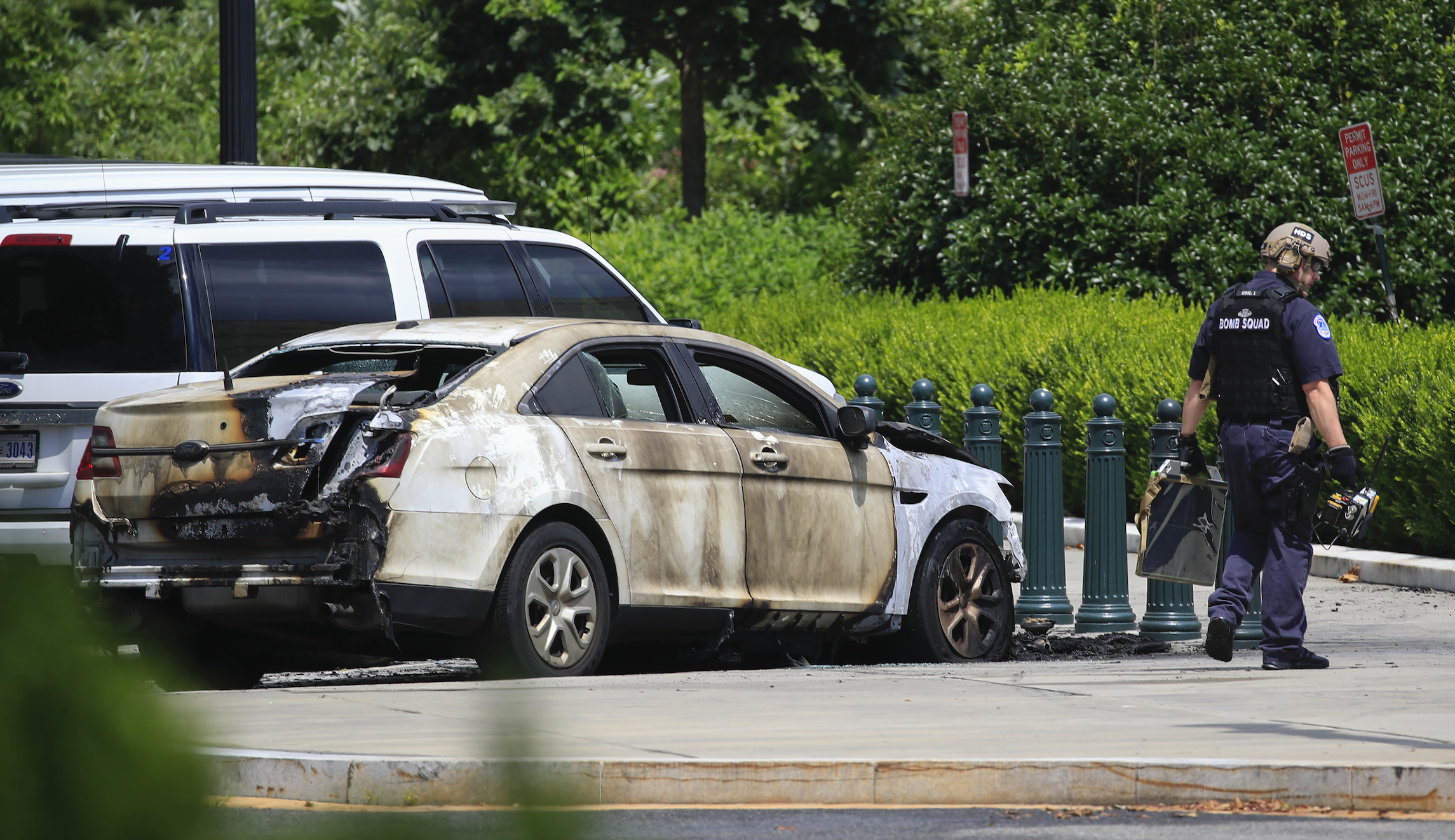 Injured man in custody after police car set on fire outside of Supreme Court