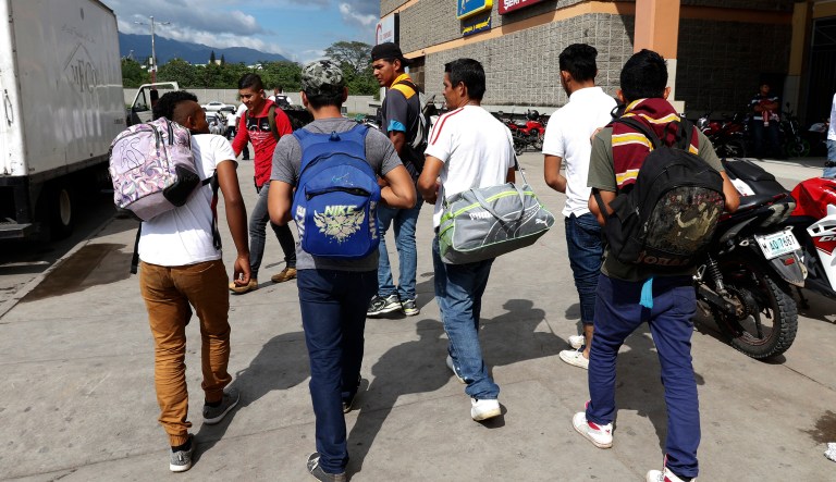 A group of young men arrive at a main bus station to join scores of other migrants forming a caravan to travel to the U.S. border, in San Pedro Sula, Honduras, Monday, Jan. 14, 2019. Yet another caravan of Central American migrants set out late Monday from Honduras, seeking to reach the U.S. border, following the same route followed by thousands on at least three caravans last year.