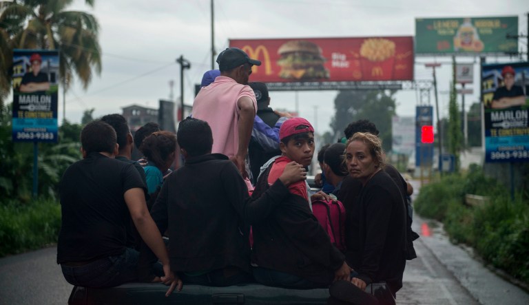 Honduran migrants ride on the bed of a pick-up truck towards the Mexican border, in Mazatenango, about 200 miles north-west from Guatemala City, Guatemala, Thursday, Oct. 18, 2018. Many of the more than 2,000 Hondurans in a migrant caravan trying to wend its way to the United States left spontaneously with little more than the clothes on their backs and what they could quickly throw into backpacks.