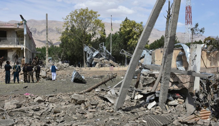 Afghan security personnel inspect the site of a car bomb blast on an intelligence compound in Aybak, the capital of the Samangan province in northern Afghanistan, Monday, July 13, 2020. Taliban insurgents launched a complex attack on the compound that began with a suicide bombing, officials said.