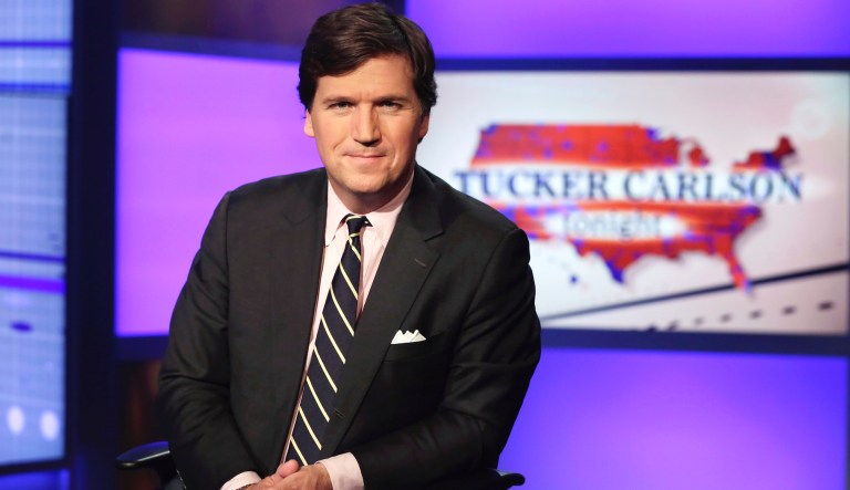 Tucker Carlson, host of "Tucker Carlson Tonight," poses for photos in a Fox News Channel studio, in New York, Thursday, March 2, 2107.