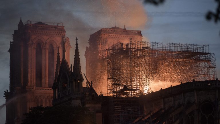Flames and smoke rise from a fire at Notre-Dame Cathedral in Paris, France, on Monday, April 15, 2019. A massive fire is ripping through the cathedral in central Paris, toppling the spire on the 850-year-old Gothic monument and leaving France in shock over the potential loss of one of the nation's most famous landmarks. 