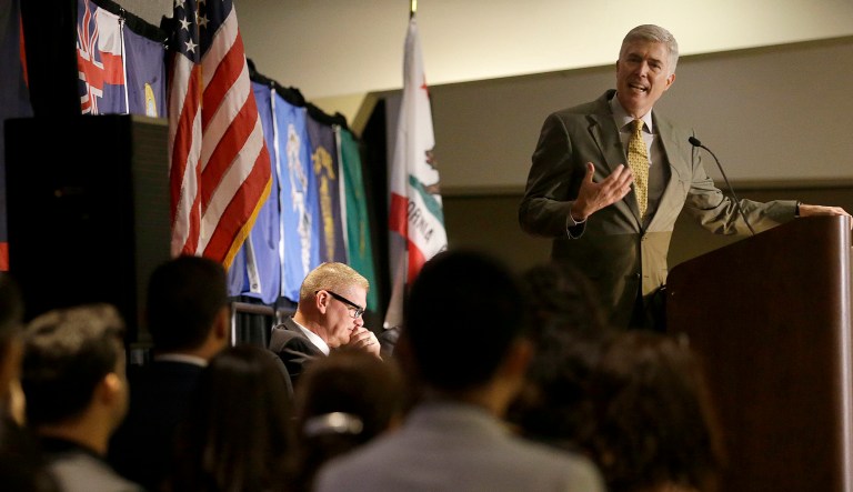 Supreme Court Justice Neil Gorsuch, top, speaks to new U.S. citizens during a naturalization ceremony at the 9th Circuit Judicial Conference in San Francisco. (AP Photo/Jeff Chiu)