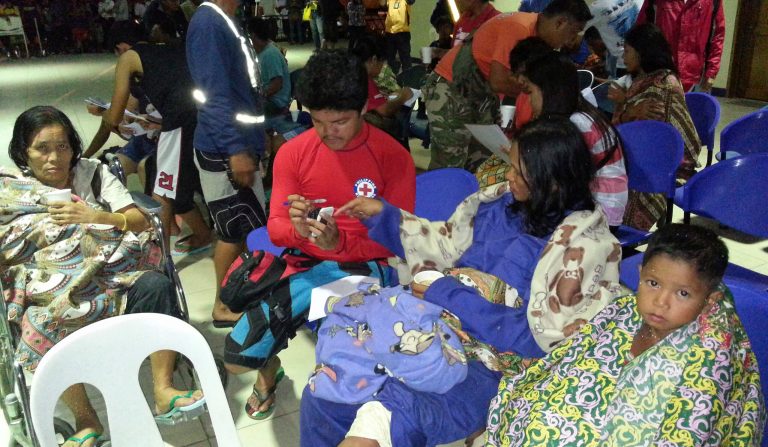 In this Saturday, Sept. 13, 2014 photo released by the Philippine National Red Cross Surigao Del Norte Chapter, survivors from the ferry M/V Maharlika II that sank after encountering steering problems, keep themselves warm with blankets as they arrive at the Lipata Port Terminal in Surigao city, central Philippines. Rescuers saved more than 100 people overnight and recovered at least three bodies from the ferry that sank in rough seas after encountering steering trouble in the central Philippines, officials said Sunday. (AP Photo/Philippine National Red Cross Surigao Del Norte Chapter)