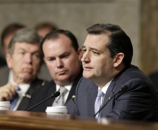 FILE - In this Jan. 31, 2013 file photo Armed Services committee member, Republican Sen. Ted Cruz of Texas, questions former Sen. Chuck Hagel (not shown), President Obama's choice for defense secretary, during Hagel's confirmation hearing on Capitol Hill in Washington. Weeks into his job, Texas Republicans are cheering Cruz's indelicate debut and embracing him as one of their own. The insurgent Republican elected with the tea party's blessing and bankroll, has run afoul of GOP mainstays, and prompted Democrats to compare his style to McCarthyism. Also seen from left are Sen.s Roy Blunt, R-Mo., and Mike Lee, R-Utah. (AP Photo/J. Scott Applewhite, File)