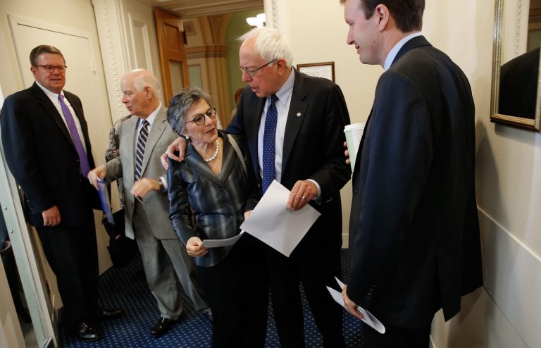 Sen. Barbara Boxer, D-Calif., center, confers with Sen. Bernie Sanders, I-Vt., second from right, before a press conference. Also pictured are Sen. Ben Cardin, D-Md., second from left and Sen. Chris Murphy D-Conn., right. (Photo by Win McNamee/Getty Images)