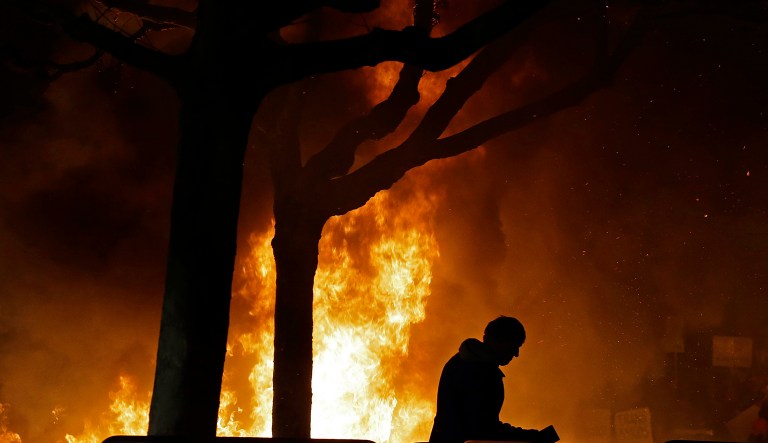 In this Feb. 1 file photo, a fire set by demonstrators protesting a scheduled speaking appearance by Breitbart News editor Milo Yiannopoulos burns on Sproul Plaza on the University of California, Berkeley campus. Liberal professors and administrators will have to take the reins in permitting alternate viewpoints if order is to be restored to America's campuses. (AP Photo/Ben Margot, File)
