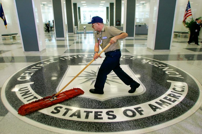 FILE - In this 2005 file photo, a workman slides a dustmop over the floor at the Central Intelligence Agency headquarters in Langley, Va., near Washington. Fifteen CIA employees were found to have committed sexual, racial or other types of harassment last year, including a supervisor who was removed from the job after engaging in 