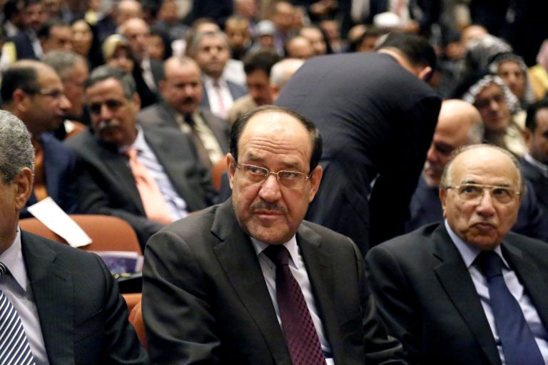 Iraqi Prime Minister Nouri al-Maliki, center, attends the first session of parliament in the heavily fortified Green Zone in Baghdad, Iraq, Tuesday, July 1, 2014. (AP Photo/Karim Kadim)