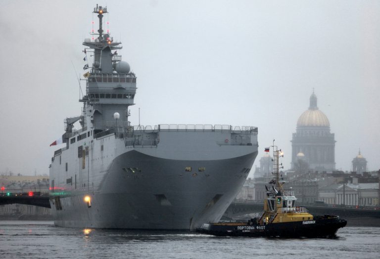 A Mistral-class French amphibious assault ship/helicopter carrier docks on the Neva River in downtown St. Petersburg, Russia, Monday, Nov. 23, 2009, with one of the city landmarks, St. Isaac's Cathedral, in the background. (AP Photo/Dmitry Lovetsky)