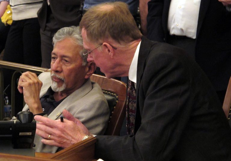 Kansas state Reps. Shanti Gandhi, left, a Topeka Republican, and David Crum, an Augusta Republican, confer during the House's debate on a school funding plan, Sunday, April 6, 2014, at the Statehouse in Topeka, Kan. (AP Photo/John Hanna)