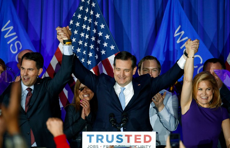 Sen. Ted Cruz, R-Texas, raises hands with Wisconsin Gov. Scott Walker, left, and his wife Heidi, right in Milwaukee. Cruz beat out Donald Trump and Gov. John Kasich to win the Wisconsin primary Tuesday night. (AP Photo/Paul Sancya)