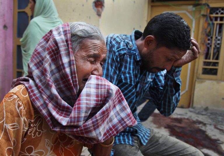 Relatives of Rajesh Kumar, who was killed in mortar shell firing allegedly from the Pakistan's side, weep inside their residential house at Masha da kothe village, in Arnia Sector near the India-Pakistan international border, about 47 kilometers (30 miles) from Jammu, India, Monday, Oct. 6, 2014. Tens of thousands of villagers were fleeing their homes in Kashmir on Monday, as Indian and Pakistani troops bombarded each another with gunfire and mortar shells over the border separating Pakistan from India's portion of the disputed region. At least nine civilians were killed. (AP Photo/Channi Anand)