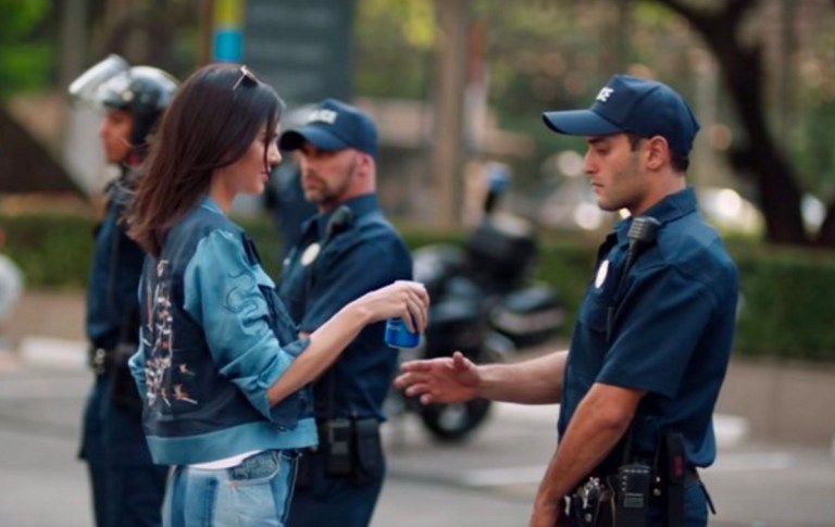 In the ad, Jenner comes face-to-face with a police officer at a protest, to whom she hands a Pepsi.(Screengrab/Twitter)