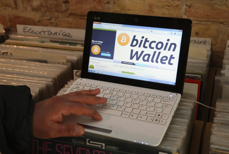 The proprietor of a shop selling vinyl records and that accepts Bitcoins for payment brings up a Bitcoin website on the proprietor's computer in Berlin, Germany. (Sean Gallup/Getty images)