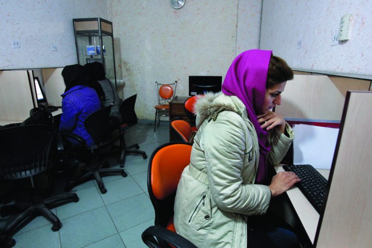 FILE - In this Monday, Feb. 13, 2012 file photo, Iranian women use computers at an Internet cafe in central Tehran. Iran's cyber monitors often tout their efforts to fight the West's 'soft war' of influence through the web, but trying to ban Google's popular Gmail may have gone too far with complaints coming even from email-starved parliament members. (AP Photo/Vahid Salemi, File)