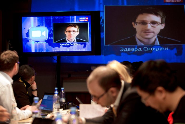 Edward Snowden, displayed on television screens, asks a question to Russian President Vladimir Putin during a nationally televised question-and-answer session, in Moscow on Thursday. (AP/Pavel Golovkin)