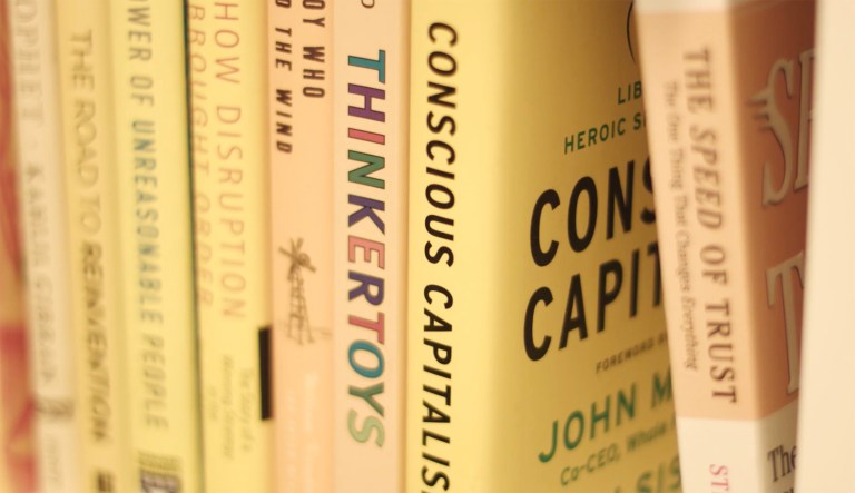 A video from the Conscious Capitalism group shows a book of the same name (pictured center-right). The group aims to demonstrate how capitalism can be beneficial for both businesses and the general public, particularly the less fortunate.