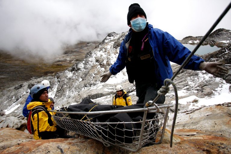   Police officers and rescuers recover bodies of victims of a helicopter crash on Mama Rosa mountain in Ocongate, Peru, Sunday, June 10, 2012. The Sikorsky S-58ET helicopter was carrying eight South Koreans and three Peruvians as well as citizens of the Netherlands, Sweden and the Czech Republic when it crashed Wednesday on Mama Rosa mountain at an altitude of about 16,000 feet (4,900 meters). (AP Photo/Juan Diego Contreras)  