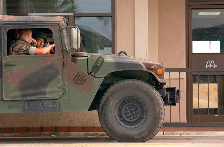 U.S. Marines collect their food in the drive through of McDonald's in Guantanamo Bay U.S. Navy Base, Cuba on Monday, Feb. 25, 2002. The fast food restaurant is the only one in Cuba. (AP Photo/ Tomas van Houtryve)