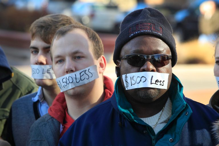 Protesters, in Dec. 2012, held a symbolic silent protest in Lansing, Mich., a day after thousands of protesters rallied on the grounds as lawmakers pushed final versions of right-to-work legislation. Today, Michiganâs highest tribunal denied Gov. Rick Snyderâs request that it review the stateâs recently approved right-to-work law. (Carlos Osorio/AP)