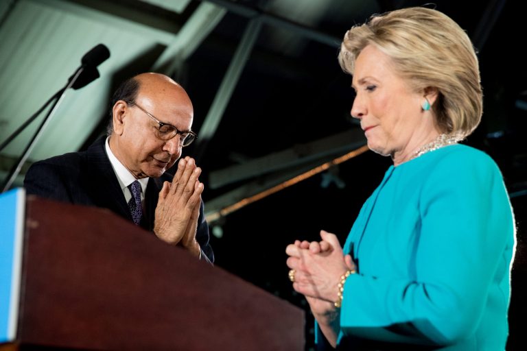 Khizr Khan, the father of fallen Army Capt. Humayun Khan, left, introduces Democratic presidential candidate Hillary Clinton, right, during a rally at The Armory at the Radisson Hotel in Manchester, N.H., Sunday, Nov. 6, 2016. (AP Photo/Andrew Harnik)