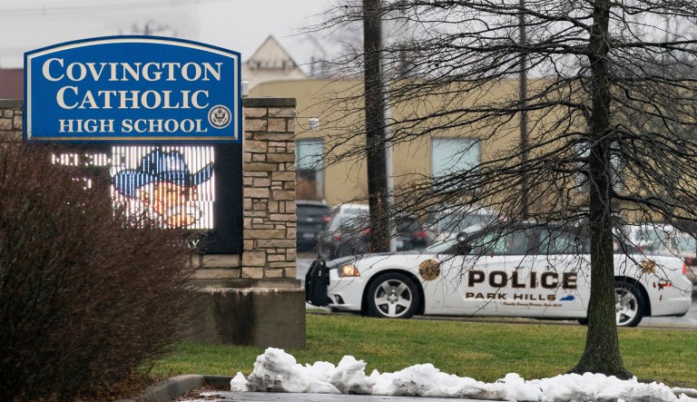A police car sits at the entrance to Covington Catholic High School in Park Hills, Ky., Saturday, Jan 19, 2019. A diocese in Kentucky apologized Saturday after videos emerged showing students from the Catholic boys' high school mocking Native Americans outside the Lincoln Memorial on Friday after a rally in Washington.