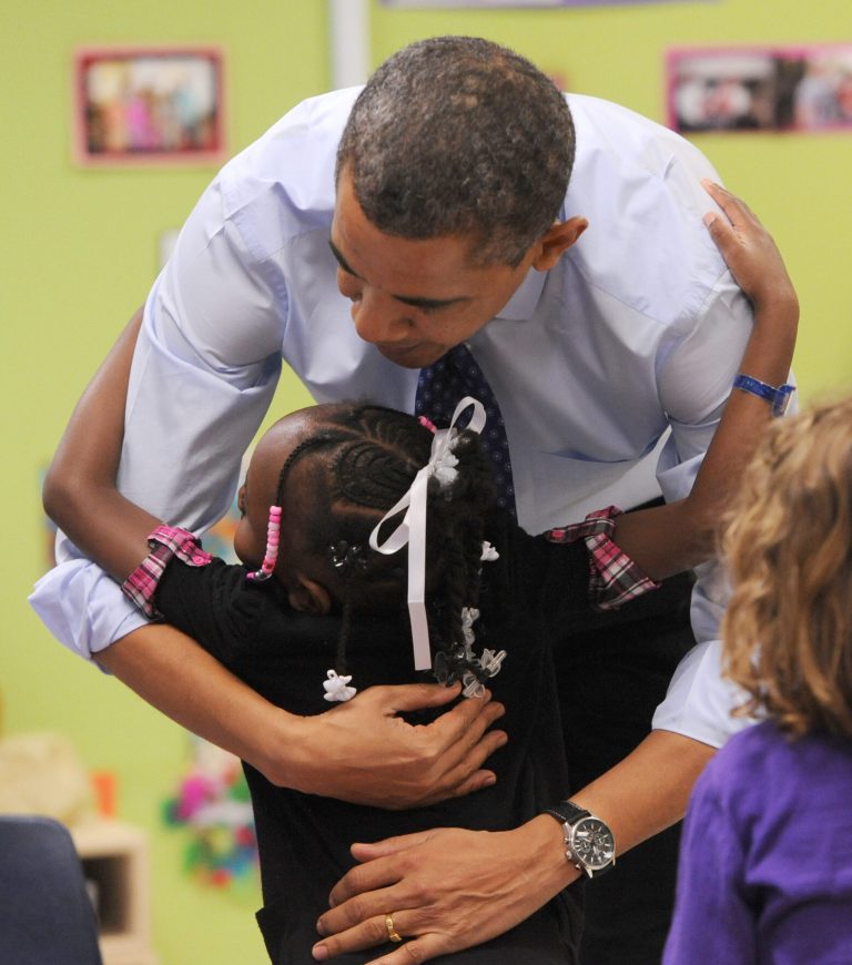 President Obama gets a hug from a child at College Heights Early Childhood Learning Center, in Decatur, Ga., on Thursday, Feb. 14, 2013. (AP Photo/Atlanta Journal-Constitution, Johnny Crawford, Pool)