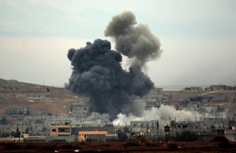 Thick smoke rises following an airstrike by the US-led coalition in Kobani, Syria while fighting continued between Syrian Kurds and the militants of Islamic State group, as seen from Mursitpinar on the outskirts of Suruc, at the Turkey-Syria border, Tuesday, Oct. 14, 2014. Kobani, also known as Ayn Arab, and its surrounding areas, has been under assault by extremists of the Islamic State group since mid-September and is being defended by Kurdish fighters. (AP Photo/Lefteris Pitarakis)