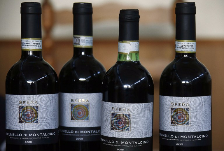 Bottles of wine falsely labeled as prized Brunello di Montalcino are displayed during a press conference in Siena, Italy, Thursday, May 29, 2014. Italian police have seized about 30,000 bottles of wine falsely labeled as prized Brunello di Montalcino, Chianti Classico and other premium wines. Siena Carabinieri Col. Marco Grandini said investigators were alerted to the fraud by consumers who recognized the impostors as 
