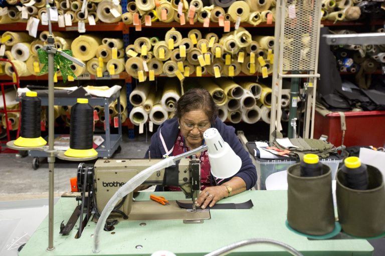 In this Sept. 19, 2014 photo, Rosa Pantoja sews a bullet proof vest together in the Research and Development department of the Point Blank Body Armor factory in Pompano Beach, Fla. The Labor Department releases the Producer Price Index for September on Wednesday, Oct. 15, 2014. (AP Photo/J Pat Carter)