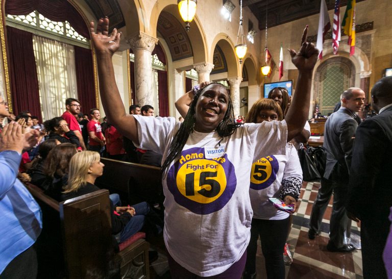 Workers react as the Los Angeles City Council votes 13-1 to raise the minimum wage to $15 an hour by 2020, but a second vote is required for final approval because the tally was not unanimous, in Los Angeles, Wednesday, June 3, 2015. (AP Photo)Â 