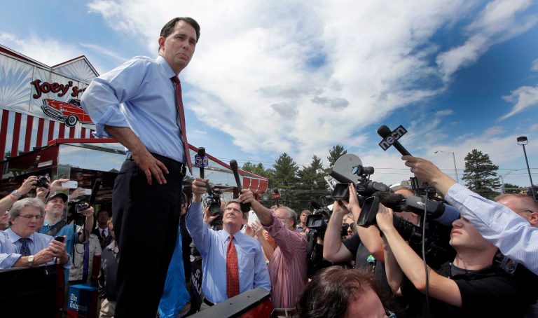 Republican presidential candidate, Wisconsin Gov. Scott Walker, R-Wis., speaks to an overflow crowd from the back of a pickup truck outside Joey's Diner, Thursday, July 16, 2015, in Amherst, N.H. (AP Photo/Jim Cole)