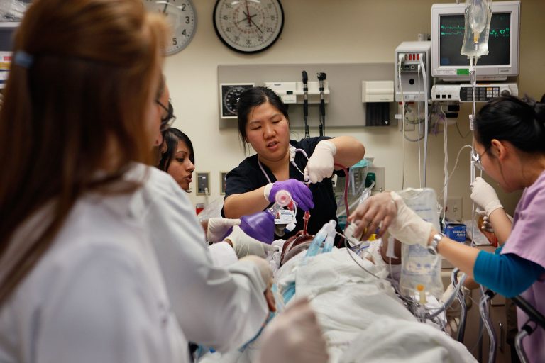 Staff in the Trauma Unit at the John H. Stroger Jr. Cook County Hospital try to save the life of a man who was hit by a car November 6, 2009 in Chicago, Illinois. (Photo by Scott Olson/Getty Images)