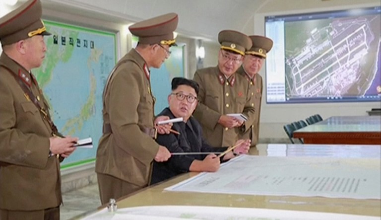 This image made from video of an Aug. 14, 2017, still image broadcast in a news bulletin on Tuesday, Aug. 15, 2017, by North Korea's KRT shows North Korean leader Kim Jong Un receiving a briefing in Pyongyang. (KRT via AP Video)