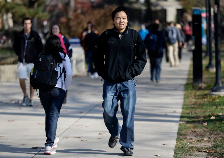 In this Friday, Nov. 9, 2012 photo, students walk on campus in Ann Arbor, Mich. (AP Photo/Paul Sancya)