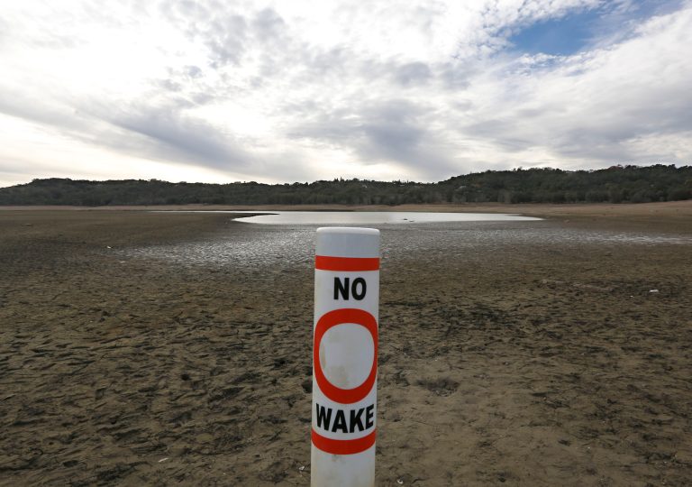 A warning buoy sits on the dry, cracked bed of Lake Mendocino near Ukiah, Calif., on Feb. 4. (AP Photo/Rich Pedroncelli)