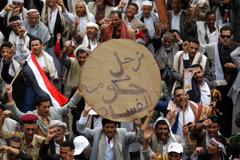 Yemeni Shiite protesters chant slogans to demand the government to step down, while attending a demonstration in Sanaa, Yemen, Friday, Aug. 29, 2014. Arabic writing on a banner reads,