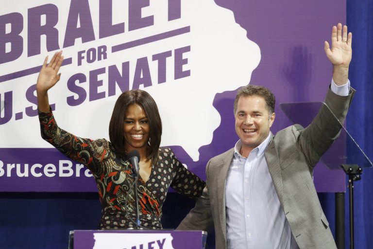 First lady Michelle Obama and U.S. Senate candidate Bruce Braley wave to the crowd after her speech at the Iowa Votes Rally on Friday, Oct. 10, 2014 at the Drake Fieldhouse in Des Moines. Obama was there to stump for Braley. (AP Photo/The Des Moines Register, Kelsey Kremer)