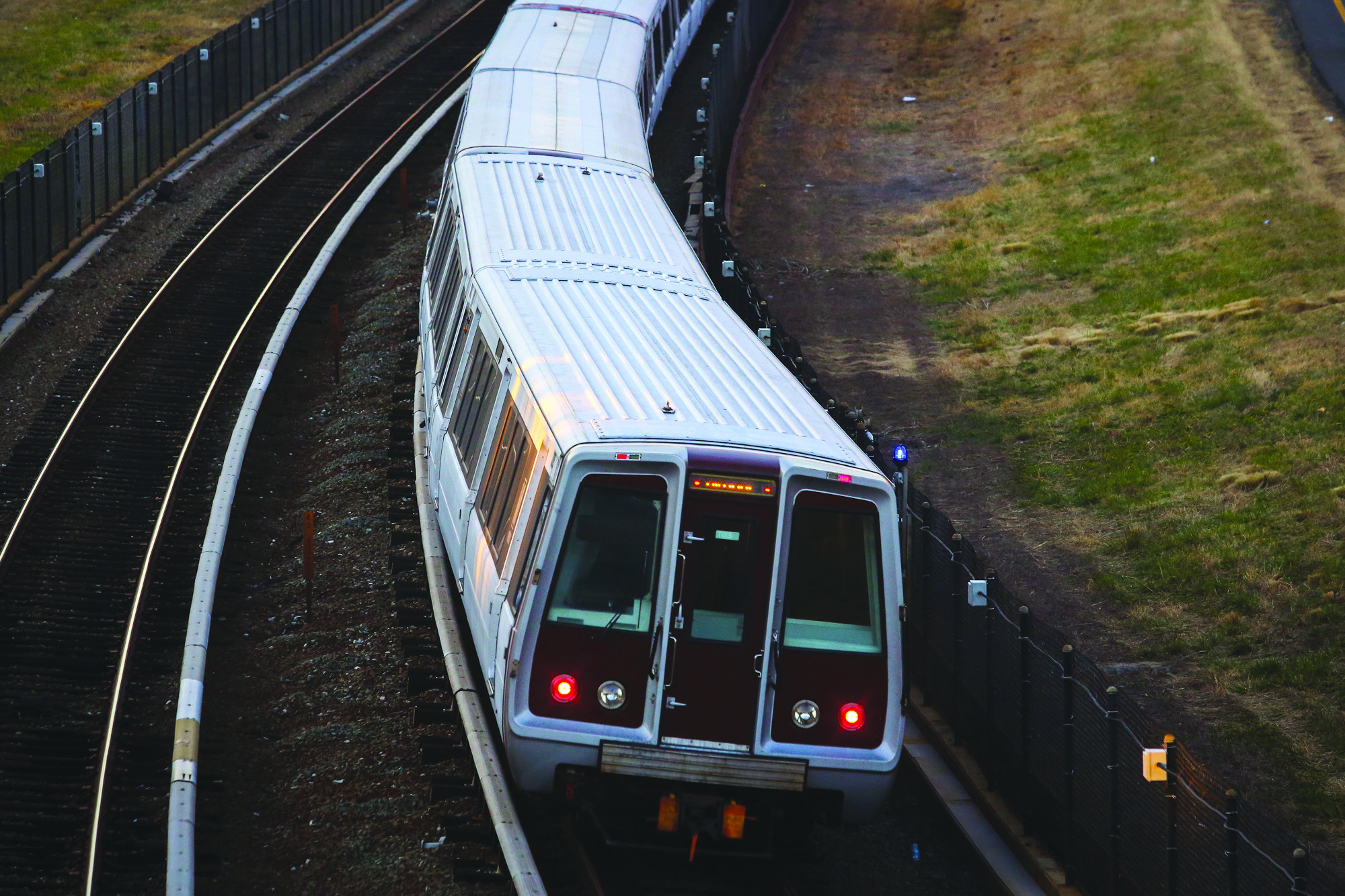 Metro train comes close to hitting two workers