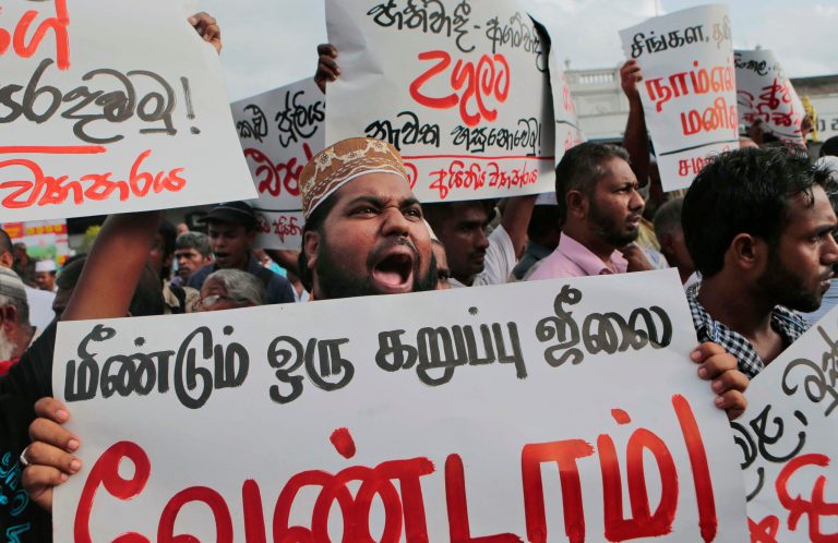Sri Lankan Muslim clergy shout slogans during a protest in Colombo, Sri Lanka, Wednesday, June 18, 2014. The European Union expressed alarm Wednesday at recent violence against Muslims in Sri Lanka in which three people died and more than 50 were injured, and urged the government to ensure that the rule of law is upheld. Placards read, foreground, âWe Don't Need Another Black July