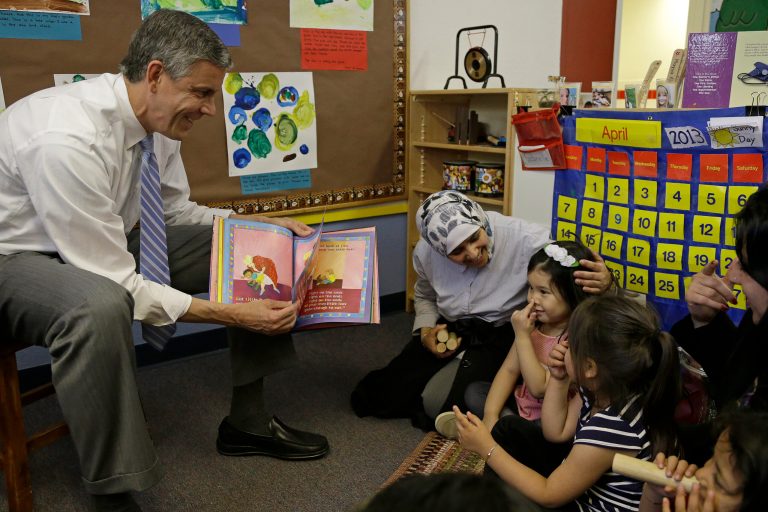  FILE - In this April 30, 2013, file photo, Education Secretary Arne Duncan, left, reads to preschool children at the Cross Cultural Family Center in San Francisco. Duncan visited the center to learn of San Francisco's Preschool for All initiative. Millions of at-risk students could fall through the cracks as the Education Department gives states permission to ignore parts of No Child Left Behind, according to a study education advocates released Tuesday, Aug. 27, 2013. (AP Photo/Ben Margot, File)  
